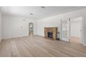 Unstaged living room featuring an inviting fireplace, neutral paint, recessed lighting, and light wood floor at 2449 16Th N St, St Petersburg, FL 33704