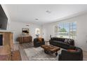 Staged living room showcasing a fireplace, window with blinds, and an archway to the dining area at 2449 16Th N St, St Petersburg, FL 33704