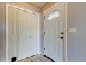 Bright entryway featuring tile floors, coat closet and a decorative glass front door at 2932 Lichen Ln # D, Clearwater, FL 33760