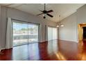 Bright living area with ceiling fan, wood floors, and sliding glass doors for natural light at 2932 Lichen Ln # D, Clearwater, FL 33760