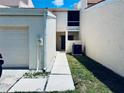 Close up of a condo featuring an attached garage, walkway and manicured lawn in a well maintained community at 4360 Outrigger Ln, Tampa, FL 33615