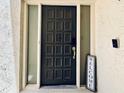 Elegant front door featuring a unique anchor knocker and welcome sign at 4360 Outrigger Ln, Tampa, FL 33615