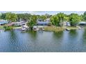 Waterfront backyard featuring multiple docks, boat lifts, and direct access to the serene lake at 5109 Vinson Dr, Tampa, FL 33610