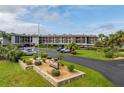 Well-maintained waterfront condo community with lush landscaping and covered parking at 5157 Silent Loop # 208, New Port Richey, FL 34652