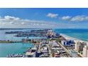Expansive aerial view of a coastal city featuring beaches, waterways, and high-rise buildings at 521 Mandalay Ave # 307, Clearwater Beach, FL 33767