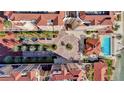 Overhead shot of a complex with a central courtyard, pool, and meticulously landscaped grounds at 521 Mandalay Ave # 307, Clearwater Beach, FL 33767