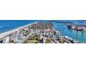 Scenic aerial view showcasing a coastal town with a beautiful beach and waterfront properties at 521 Mandalay Ave # 307, Clearwater Beach, FL 33767
