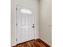 Elegant front door featuring a decorative window pane, complemented by wood-look flooring at 5435 Birchwood Rd, Spring Hill, FL 34608