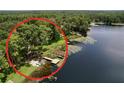 Scenic aerial view featuring a lush tree line and waterfront access, highlighting the natural beauty of the property at 5720 Half Moon Lake Rd, Tampa, FL 33625