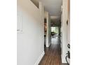 Bright hallway with hardwood floors leading to the kitchen and living area at 6109 Bayside Key Dr, Tampa, FL 33615