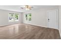 Bright, airy living room features hardwood floors, a ceiling fan, and ample natural light at 6489 30Th N St, St Petersburg, FL 33702