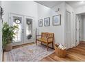 Bright foyer with glass paneled doors, a cozy wooden bench, and elegant decor, creating a welcoming entrance at 6611 Surfside Blvd, Apollo Beach, FL 33572