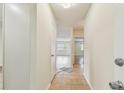 Bright hallway featuring neutral tones, tiled flooring, and views into other rooms at 701 Poinsettia Rd # 340, Belleair, FL 33756