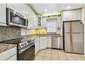 Stylish kitchen with stainless steel appliances, granite countertops, and ample cabinet space at 701 Poinsettia Rd # 340, Belleair, FL 33756