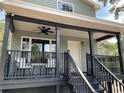 Attractive two-story home with a spacious covered porch and contemporary design elements at 7152 Sandy Ln, Wesley Chapel, FL 33544