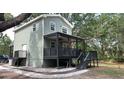 Two-story home with stylish porch, offering outdoor living and modern comfort at 7152 Sandy Ln, Wesley Chapel, FL 33544