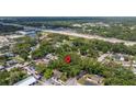 Aerial view of land featuring mature trees near a busy highway, close to local amenities at 717 E 137Th Ave, Tampa, FL 33613