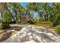 Inviting two-story home with a spacious front yard, mature trees, and a long driveway at 717 E 137Th Ave, Tampa, FL 33613
