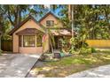 Charming two-story home featuring a manicured lawn, mature trees, and an inviting entrance at 717 E 137Th Ave, Tampa, FL 33613