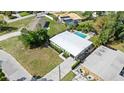 Aerial view of home with pool, green yard, and modern exterior, close to the street at 7304 Lakeside Blvd, Tampa, FL 33614