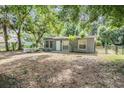 Quaint single-story home with a welcoming fenced front yard and mature trees at 7347 Pulsar St, New Port Richey, FL 34652