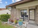 Inviting front porch with seating, decorative plants, and a well-manicured garden, perfect for enjoying the outdoors at 7360 Ulmerton Rd # 18A, Largo, FL 33771