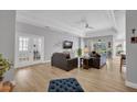 Bright living room with hardwood floors, neutral colors, modern furniture, and french doors at 8223 Haven Harbour Way, Bradenton, FL 34212