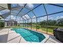 Sparkling screened-in pool with picturesque lake views, perfect for relaxation and outdoor enjoyment at 8223 Haven Harbour Way, Bradenton, FL 34212