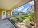 Front porch view of landscaped home exterior with decorative stone pathway at 9631 Oak Ne St, St Petersburg, FL 33702