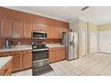 Well-equipped kitchen featuring stainless steel appliances, ample cabinet space, and tile flooring at 10263 Devonshire Lake Dr, Tampa, FL 33647