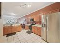 Spacious kitchen with stainless steel appliances, tile flooring, and a view to living spaces at 10263 Devonshire Lake Dr, Tampa, FL 33647