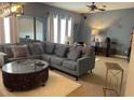 Cozy living room with a plush sectional sofa, decorative mirrors, and a soft rug for added comfort at 10713 Shady Preserve Dr, Riverview, FL 33579