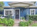 Inviting front entrance with a decorative door, well manicured bushes, and charming exterior details at 1115 45Th N St, St Petersburg, FL 33713