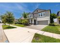 Two-story home with covered entryway, gray siding, and well-manicured lawn at 11320 Chilly Water Ct, Riverview, FL 33569