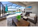 Screened outdoor living area with pool, spa, ceiling fan, and television at 11320 Chilly Water Ct, Riverview, FL 33569