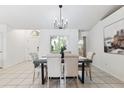 Elegant dining room with a stylish table, upholstered chairs, decorative lighting, and a bright, open layout at 11510 92Nd Way, Largo, FL 33773