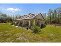 Side exterior view showcasing the home's design, landscaping, and outdoor space at 12090 Thames Ave, Weeki Wachee, FL 34614