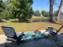 Relaxing backyard with patio featuring comfortable seating and views of the serene pond at 12838 Tallowood Dr, Riverview, FL 33579
