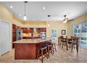 Spacious kitchen with a large island, granite countertops, modern appliances, and an adjacent breakfast nook area at 137 Woodcreek E Dr, Safety Harbor, FL 34695