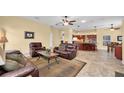 Comfortable living room featuring tile floors and an open floor plan, connecting to the kitchen and other living spaces at 137 Woodcreek E Dr, Safety Harbor, FL 34695