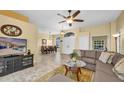 Inviting living room featuring tile flooring, comfortable seating, and arched doorway, with a view into the dining room at 137 Woodcreek E Dr, Safety Harbor, FL 34695
