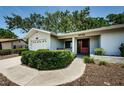 Cozy single-story home with an attached garage and a neatly trimmed front yard at 1648 Concord St, Dunedin, FL 34698