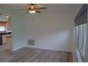 Light-filled living area transitioning into the kitchen, featuring updated floors and fixtures at 1665 Grove St, Clearwater, FL 33755
