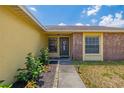 The home's front door is accompanied by trimmed bushes and a walkway at 1720 Fruitridge St, Brandon, FL 33510