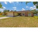 Inviting single-story residence featuring a well-maintained lawn and a convenient two-car garage at 1720 Fruitridge St, Brandon, FL 33510