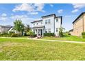Two story home on a manicured lawn with some landscaping surrounded by green grass at 17589 Cruiser Bnd, Land O Lakes, FL 34638