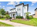 Charming two-story home with manicured lawn and landscaping under a sunny sky at 17589 Cruiser Bnd, Land O Lakes, FL 34638