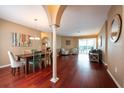 Open-concept living room with elegant hardwood floors and a neutral color palette at 18518 Bittern Ave, Lutz, FL 33558