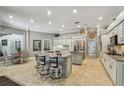 Spacious open kitchen with a kitchen island, granite countertops, and stainless steel appliances at 1877 Muirfield Way, Oldsmar, FL 34677