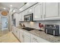 Modern kitchen with granite countertops, and stainless steel appliances at 1877 Muirfield Way, Oldsmar, FL 34677